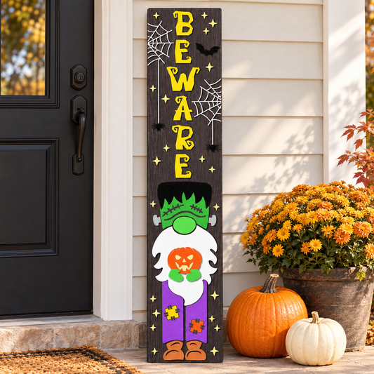 Beware Frankenstein gnome Halloween porch sign leaning by a front door with mums and pumpkins